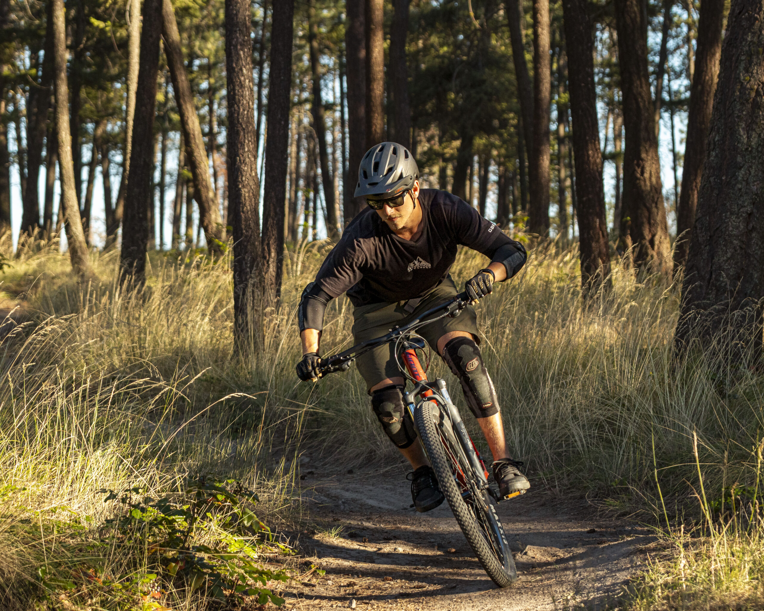 A photo of a mountain biker riding a trail.