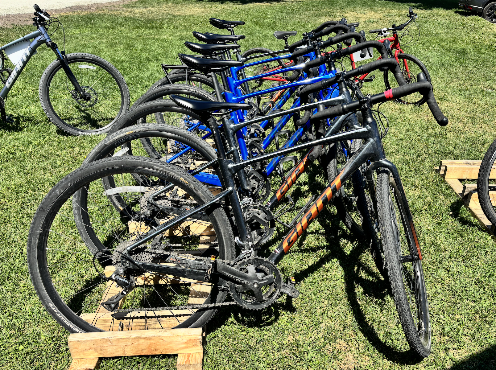 A photo of a bike rack full of gravel bikes.